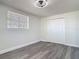 Bright bedroom with sleek flooring, window, and double door closet at 1002 Charles St, Port Orange, FL 32129