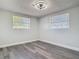 Bright bedroom with sleek flooring, and two windows at 1002 Charles St, Port Orange, FL 32129