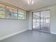 Bonus room features neutral walls, a window, and sliding doors to the outdoor pool area at 1002 Charles St, Port Orange, FL 32129