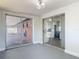 Bonus room with sliding glass doors providing access to a patio and glimpses of the kitchen at 1002 Charles St, Port Orange, FL 32129