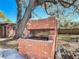 Outdoor brick grill beneath a shade tree perfect for backyard BBQs at 1002 Charles St, Port Orange, FL 32129