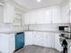 Charming kitchen showcases white cabinetry with stainless steel hardware and gray countertops at 1002 Charles St, Port Orange, FL 32129
