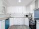 Updated kitchen features white cabinets, granite countertops, and stainless steel appliances at 1002 Charles St, Port Orange, FL 32129