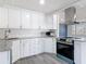 Updated kitchen features white cabinets, granite countertops, and stainless steel appliances at 1002 Charles St, Port Orange, FL 32129