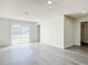 Spacious living room with wood-look floors, natural light, and neutral paint at 1002 Charles St, Port Orange, FL 32129