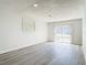 Bright living room with wood-look floors and sliding glass door to the backyard at 1002 Charles St, Port Orange, FL 32129