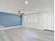 Newly renovated living room with durable, gray wood-look flooring and a modern ceiling fan at 1002 Charles St, Port Orange, FL 32129
