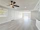 Spacious living room featuring fresh paint and gray wood-look floors at 1002 Charles St, Port Orange, FL 32129