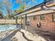 Covered patio featuring brick accents, a nearby pool, and concrete flooring offers ideal outdoor living and entertaining space at 1002 Charles St, Port Orange, FL 32129