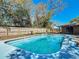 Private fenced backyard with a refreshing pool and beautiful trees at 1002 Charles St, Port Orange, FL 32129