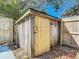 A wooden shed provides ample storage space in the backyard at 1002 Charles St, Port Orange, FL 32129