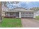 Charming single-story home with well-maintained lawn, screened porch and two-car garage at 102 Underbrush Trl, Port Orange, FL 32128