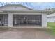 View of the garage exterior with screen door and driveway at 102 Underbrush Trl, Port Orange, FL 32128