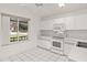Well-lit kitchen with ample counter space, stainless steel appliances, and tile flooring at 102 Underbrush Trl, Port Orange, FL 32128