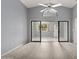 Bright living room with wood-look flooring and sliding glass doors to outdoor area at 102 Underbrush Trl, Port Orange, FL 32128