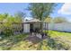 View of backyard area including a chicken coop and fenced yard at 1058 W Seagate Dr, Deltona, FL 32725