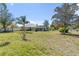 Wide shot of backyard with screened in pool area and chicken coop and fenced in area at 1058 W Seagate Dr, Deltona, FL 32725