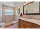 A stylish bathroom featuring stone tile in the shower, floors and vanity at 1058 W Seagate Dr, Deltona, FL 32725