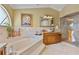 This bathroom features an open tub between two vanities, as well as a glass door shower at 1058 W Seagate Dr, Deltona, FL 32725