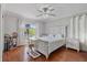 Bright bedroom featuring light walls, modern ceiling fan, and hardwood floors at 1058 W Seagate Dr, Deltona, FL 32725
