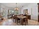 Dining room with wood table, upholstered chairs, chandelier, and view to outside at 1058 W Seagate Dr, Deltona, FL 32725