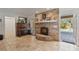 Living room fireplace features brick surround, raised hearth, and access to the outdoor pool area at 1058 W Seagate Dr, Deltona, FL 32725
