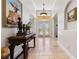 Grand foyer featuring soaring ceilings, travertine floors and a decorative console table at 1058 W Seagate Dr, Deltona, FL 32725