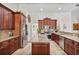 Gourmet kitchen featuring granite countertops, stainless appliances, and tile flooring at 1058 W Seagate Dr, Deltona, FL 32725