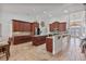 Open kitchen with dark wood cabinets, granite countertops, and center island with breakfast bar at 1058 W Seagate Dr, Deltona, FL 32725