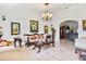 Bright living room featuring neutral decor, travertine floors, and a classic chandelier at 1058 W Seagate Dr, Deltona, FL 32725