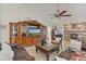 Spacious living room featuring a brick fireplace, built-in shelving, and comfortable seating at 1058 W Seagate Dr, Deltona, FL 32725