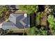 Aerial view showcasing the home's layout, screened lanai, and picturesque pond-side setting at 1062 Golf View Estates Dr, Orange City, FL 32763