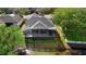 Aerial view of a home with a screened-in patio backing onto a serene pond and lush landscaping at 1062 Golf View Estates Dr, Orange City, FL 32763
