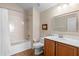 Bright bathroom features a shower-tub combo, neutral tile, and a classic vanity with ample storage at 1062 Golf View Estates Dr, Orange City, FL 32763