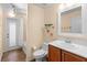 Well-lit bathroom features a vanity, toilet, framed mirror, and shower-tub combo at 1062 Golf View Estates Dr, Orange City, FL 32763