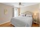 Cozy bedroom with hardwood floors, a ceiling fan, and decorative pillows on a queen size bed at 1062 Golf View Estates Dr, Orange City, FL 32763