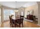 Spacious dining area features stylish chandelier and table with dark wood chairs at 1062 Golf View Estates Dr, Orange City, FL 32763