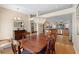 Dining room with dark wood table, upholstered chairs, modern chandelier, and open floor plan at 1062 Golf View Estates Dr, Orange City, FL 32763