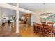 Open dining area features a hanging chandelier, stainless appliances, and lots of light at 1062 Golf View Estates Dr, Orange City, FL 32763