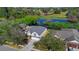 Beautiful house with a pond view, surrounded by lush greenery and trees in a residential neighborhood at 1062 Golf View Estates Dr, Orange City, FL 32763