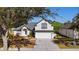 Charming two-story home featuring a well-maintained lawn and a two-car garage at 1062 Golf View Estates Dr, Orange City, FL 32763
