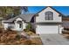 Beautifully landscaped home exterior with a two-car garage and gray roof at 1062 Golf View Estates Dr, Orange City, FL 32763