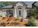 Stunning front entrance with decorative plants and a glass-paneled door under a porch at 1062 Golf View Estates Dr, Orange City, FL 32763