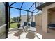 Bright, screened lanai with lounge chairs and potted plants, offering a tranquil outdoor space at 1062 Golf View Estates Dr, Orange City, FL 32763