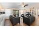 Bright living room features neutral decor, ceiling fan, and sliding glass doors to the outdoor patio at 1062 Golf View Estates Dr, Orange City, FL 32763