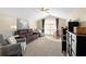 Open-concept living room features vaulted ceiling, comfortable seating, and natural light at 1062 Golf View Estates Dr, Orange City, FL 32763