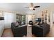 Bright living room features neutral decor, ceiling fan, and sliding glass doors to the outdoor patio at 1062 Golf View Estates Dr, Orange City, FL 32763