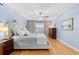 Stylish main bedroom is complete with wood floors and neutral furniture at 1062 Golf View Estates Dr, Orange City, FL 32763