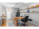 Bright office space with built in shelving, natural lighting, desk and rolling office chair at 1062 Golf View Estates Dr, Orange City, FL 32763