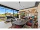 Spacious outdoor patio with dining area and grill overlooking the water at 1062 Golf View Estates Dr, Orange City, FL 32763
